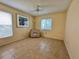 Bright bedroom with tile flooring, a ceiling fan, and natural light from two windows at 5804 Garden Lakes Fern, Bradenton, FL 34203