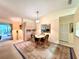Dining area with carpet flooring, modern lighting, and a sliding door to the outdoors at 5804 Garden Lakes Fern, Bradenton, FL 34203