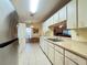 Spacious kitchen featuring tile flooring, white cabinets, and stainless steel refrigerator at 5804 Garden Lakes Fern, Bradenton, FL 34203