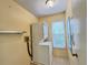 Laundry room with stackable washer and dryer and a window for natural light at 5804 Garden Lakes Fern, Bradenton, FL 34203