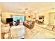 Cozy living room featuring carpet floors, a ceiling fan, and a comfortable furniture set at 5804 Garden Lakes Fern, Bradenton, FL 34203