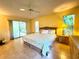 Spacious bedroom with tile flooring, natural light, and outdoor access to the lanai at 5804 Garden Lakes Fern, Bradenton, FL 34203
