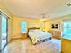Large main bedroom with tile flooring, natural light, and a sliding glass door to the exterior at 5804 Garden Lakes Fern, Bradenton, FL 34203