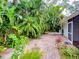 Brick patio surrounded by lush tropical landscaping, perfect for outdoor entertaining at 5804 Garden Lakes Fern, Bradenton, FL 34203