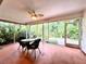 Relaxing screened porch with table and chairs overlooking lush tropical foliage at 5804 Garden Lakes Fern, Bradenton, FL 34203