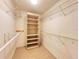 Spacious walk-in closet with multiple shelves and hanging racks for ample storage space at 5804 Garden Lakes Fern, Bradenton, FL 34203