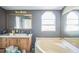 Bathroom featuring double sinks, a separate shower, a tub, and tiled floors at 5829 Coventry Dr, Tampa, FL 33615