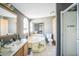 Bathroom featuring double sinks, a separate shower, a tub, and tiled floors at 5829 Coventry Dr, Tampa, FL 33615