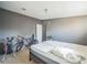 Bedroom featuring gray walls and neutral carpet; includes golf clubs and bicycle for active lifestyle at 5829 Coventry Dr, Tampa, FL 33615