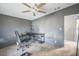 Bedroom featuring a desk, ceiling fan, and neutral colored walls and floors at 5829 Coventry Dr, Tampa, FL 33615