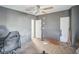 Bedroom boasts gray walls, neutral carpet, ceiling fan, and ample closet space at 5829 Coventry Dr, Tampa, FL 33615