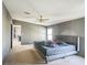 Main bedroom with a king bed, ceiling fan, and closet at 5829 Coventry Dr, Tampa, FL 33615