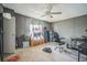 Neutral bedroom with ceiling fan, gray walls, carpeted floors, and curated skateboarding and snowboard aesthetic at 5829 Coventry Dr, Tampa, FL 33615