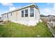 Side angle view of home, showing exterior siding and lawn at 5829 Coventry Dr, Tampa, FL 33615