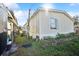 Angle side view of mobile home with exterior siding and nearby foliage at 5829 Coventry Dr, Tampa, FL 33615