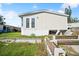Exterior view showing a quaint mobile home with white siding and manicured lawn at 5829 Coventry Dr, Tampa, FL 33615