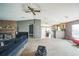 Open living space with exposed brick fireplace, ceiling fan, and natural light at 5829 Coventry Dr, Tampa, FL 33615