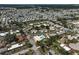 Panoramic aerial view showcases a large community, pond, and amenities like a pool and shuffleboard courts at 602 Park Cir, Bradenton, FL 34207