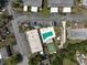 Aerial view of community pool and shuffleboard courts, surrounded by well-maintained residential homes and lush landscaping at 602 Park Cir, Bradenton, FL 34207