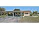 Single Gathering home featuring a carport, minimalist garden, and manicured lawn at 602 Park Cir, Bradenton, FL 34207