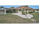 Cozy home with a carport, manicured bushes, rock garden, and well-maintained grassy lawn at 602 Park Cir, Bradenton, FL 34207