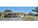 A charming one-story home featuring a carport, green lawn, and minimalist landscaping at 602 Park Cir, Bradenton, FL 34207