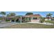 Charming home boasts a covered carport, a well-kept lawn, and minimalist front landscaping at 602 Park Cir, Bradenton, FL 34207