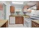Functional kitchen design featuring wood cabinets, white appliances, and tile floors at 602 Park Cir, Bradenton, FL 34207