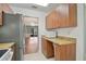 Open concept kitchen with stainless steel appliances, wood cabinets, and tile floors at 602 Park Cir, Bradenton, FL 34207