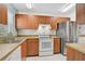 Efficient kitchen with stainless steel refrigerator and white appliances at 602 Park Cir, Bradenton, FL 34207