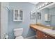 Bathroom with single sink vanity, mirrored medicine cabinet, and commode at 602 Park Cir, Bradenton, FL 34207