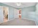 Bedroom features a ceiling fan, light-colored walls, and two doorways leading to other rooms at 602 Park Cir, Bradenton, FL 34207
