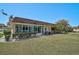 Exterior view of the home featuring an enclosed patio and manicured backyard at 602 Park Cir, Bradenton, FL 34207