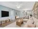 Bright living room with modern decor, wood accents, and an open floor plan leading into the dining area at 602 Park Cir, Bradenton, FL 34207
