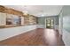 Bright living room with a rustic wood accent wall and sliding glass doors to the patio at 602 Park Cir, Bradenton, FL 34207