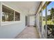Enclosed tiled patio featuring a ceiling fan, large window, and lots of natural light at 602 Park Cir, Bradenton, FL 34207