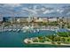 An aerial view of a city marina featuring numerous boats, waterfront buildings, and lush green spaces at 6248 Donnington Ct, Sarasota, FL 34238