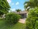 Lush backyard with manicured greenery, a charming patio, and a screened lanai, creating an inviting outdoor oasis at 6248 Donnington Ct, Sarasota, FL 34238