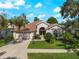 Charming single-story home with well-manicured lawn, mature trees, and a two-car garage, showcasing curb appeal at 6248 Donnington Ct, Sarasota, FL 34238