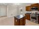 Kitchen with stainless steel appliances, granite countertops, a kitchen island and tile flooring at 6248 Donnington Ct, Sarasota, FL 34238