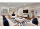 Bright, updated living room with hardwood floors, modern furniture, and large front windows and entry at 6248 Donnington Ct, Sarasota, FL 34238