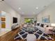 Open-concept living room with a large window with a view of the lanai, modern decor, and wood floors at 6248 Donnington Ct, Sarasota, FL 34238