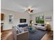 Comfortable living room with hardwood floors, stylish furnishings, a modern ceiling fan and great natural light at 6248 Donnington Ct, Sarasota, FL 34238
