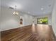 Expansive open floor plan showing beautiful wood floors and lots of light with access to the kitchen and lanai at 6248 Donnington Ct, Sarasota, FL 34238