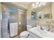 Functional bathroom features a glass-enclosed shower, bright lighting, and white cabinetry at 6422 Auburn Ave, Bradenton, FL 34207