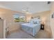 Light and airy bedroom with water views and plush blue bedding and new ceiling fan at 6422 Auburn Ave, Bradenton, FL 34207