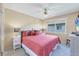 Comfortable bedroom showcasing a ceiling fan, warm peach walls, and light-colored carpet at 6422 Auburn Ave, Bradenton, FL 34207