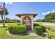 Cambridge Village sign nestled in lush greenery, welcoming residents to the 55 and older community at 6422 Auburn Ave, Bradenton, FL 34207
