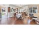 Bright dining room featuring hardwood floors, a mirrored wall, and a view of the kitchen at 6422 Auburn Ave, Bradenton, FL 34207