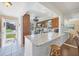 Modern kitchen with stainless steel appliances, granite countertops, and a breakfast bar with seating at 6422 Auburn Ave, Bradenton, FL 34207